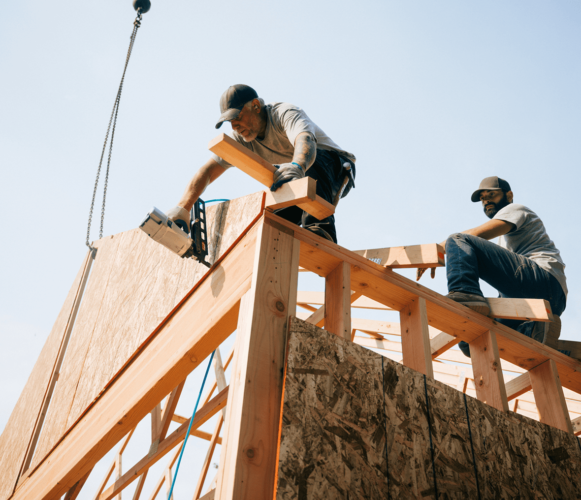 Construction workers building a wooden structure.